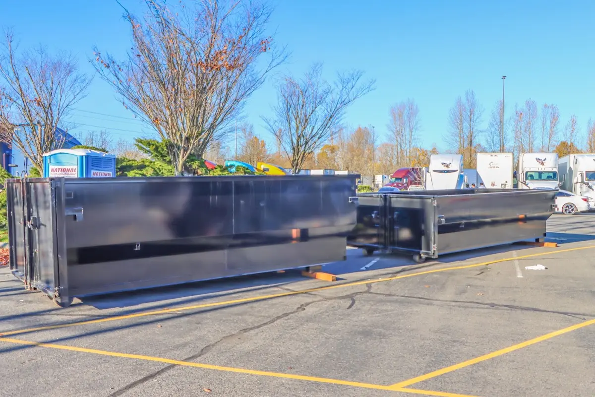 Professional dumpster rental service with roll-off container on residential driveway in Evansville